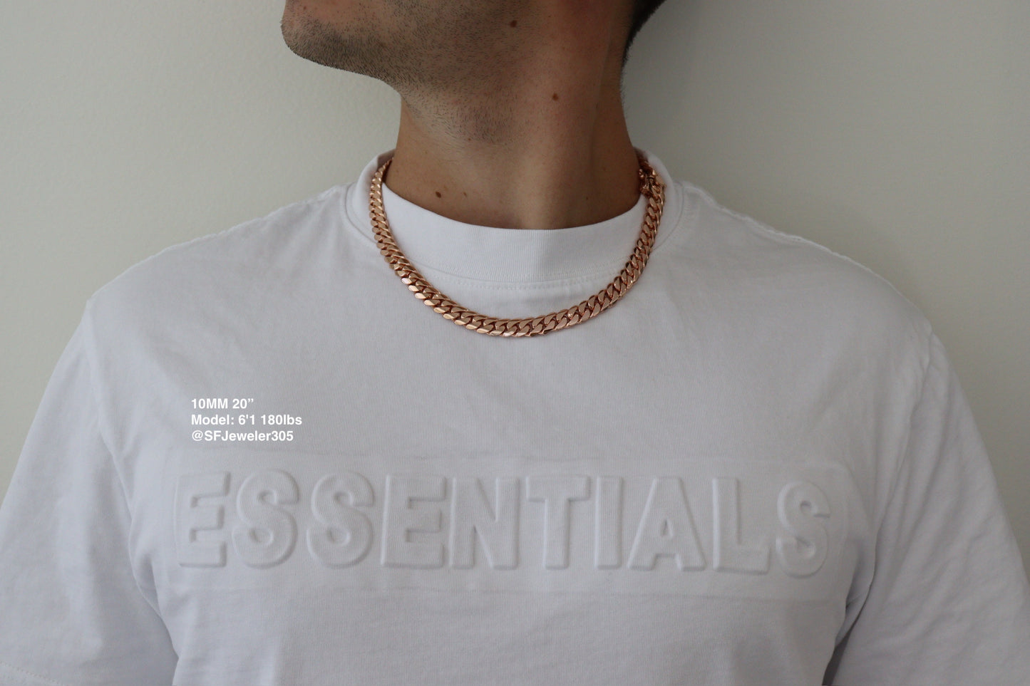 Man wearing a 10MM 10-inch rose gold over silver Cuban link chain, modeled by SF Jeweler 305. The bold Miami Cuban chain has a heavy, polished finish and is styled with a casual t-shirt.