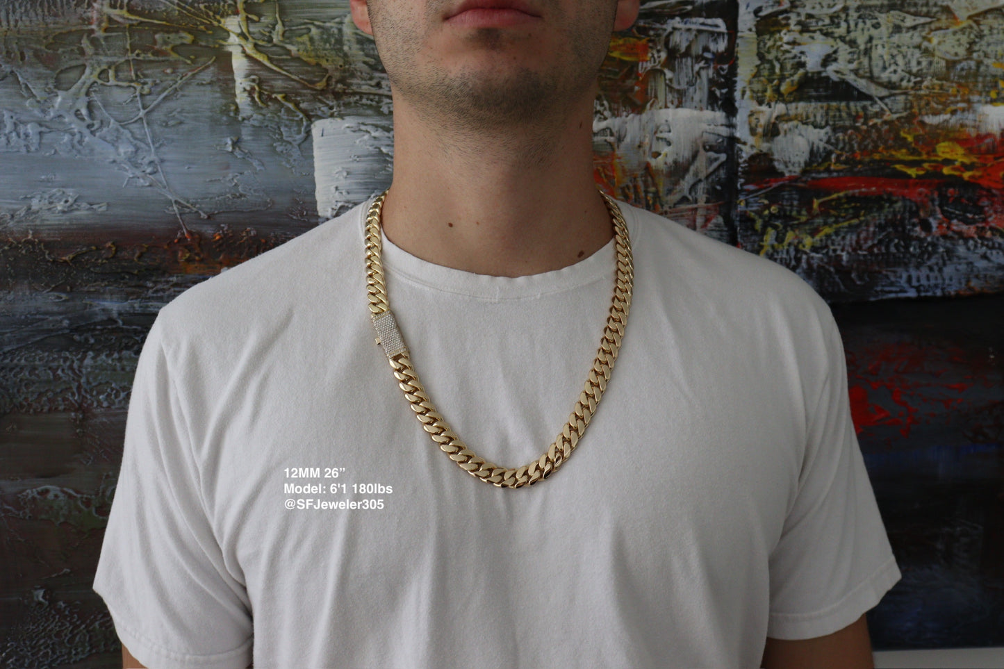 12MM Cuban Link Chain in yellow gold over silver with fully iced-out VVS1 Moissanite Stones Lock, 26-inch length, modeled on a 6’1” 180 lbs male wearing a white shirt. Jewelry by SF Jeweler 305.