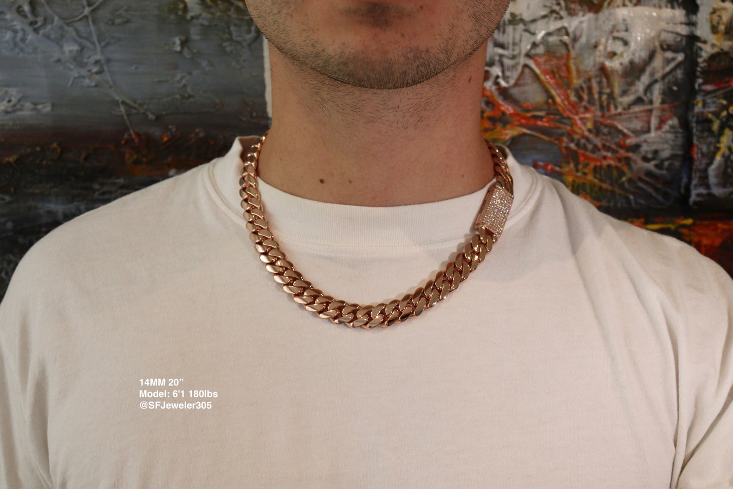 14MM Cuban Link Chain in rose gold over silver with fully iced-out VVS1 Moissanite Stones Lock, 20-inch length, modeled on a 6’1” 180 lbs male wearing a white shirt. Jewelry by SF Jeweler 305.