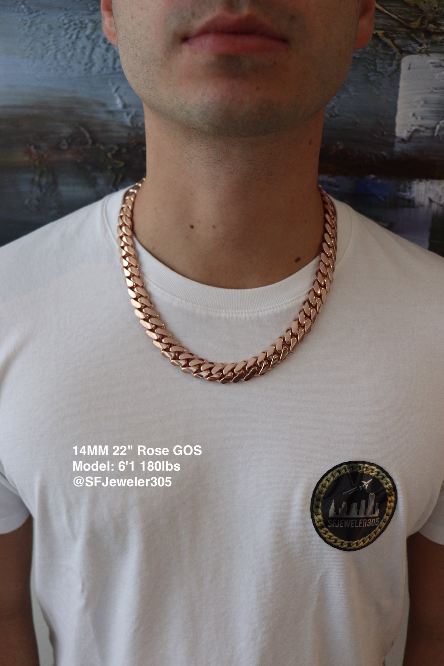 Man wearing a 14MM 22 inch rose gold over silver Cuban link chain, modeled by SF Jeweler 305. The bold Miami Cuban chain has a heavy, polished finish and is styled with a casual t-shirt.