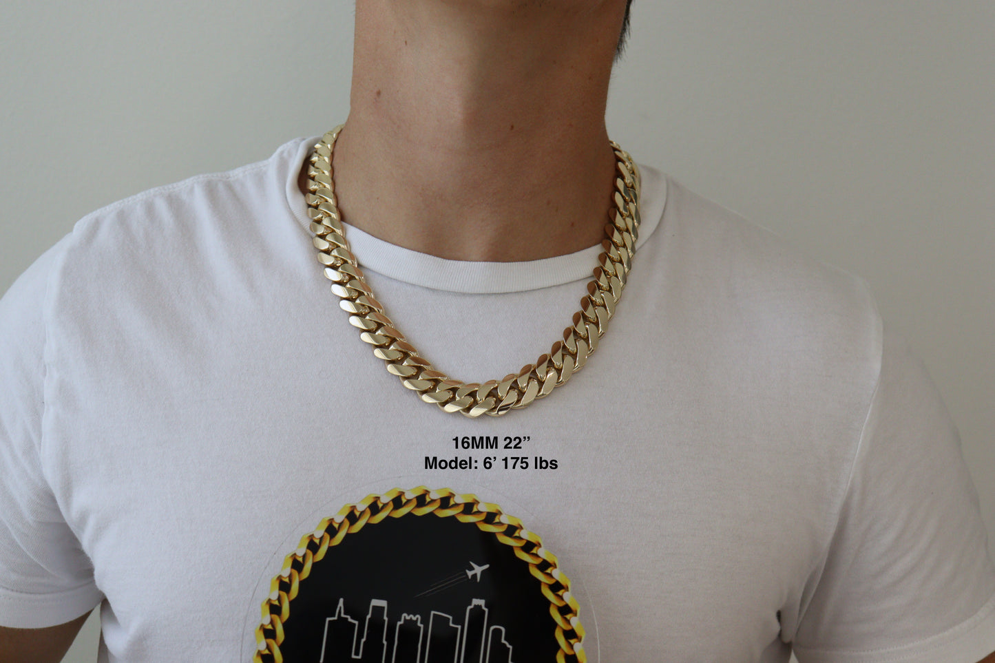 Man wearing a 16MM 22 inch yellow gold over silver Cuban link chain, modeled by SF Jeweler 305. The bold Miami Cuban chain has a heavy, polished finish and is styled with a casual t-shirt.