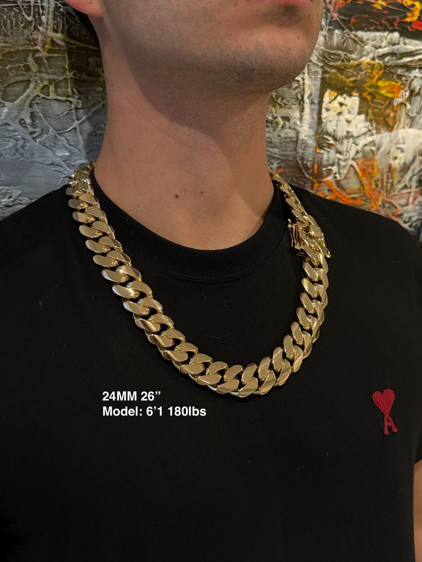 Man wearing a 24MM 26-inch Yellow gold over silver Cuban link chain, modeled by SF Jeweler 305. The bold Miami Cuban chain has a heavy, polished finish and is styled with a casual t-shirt.