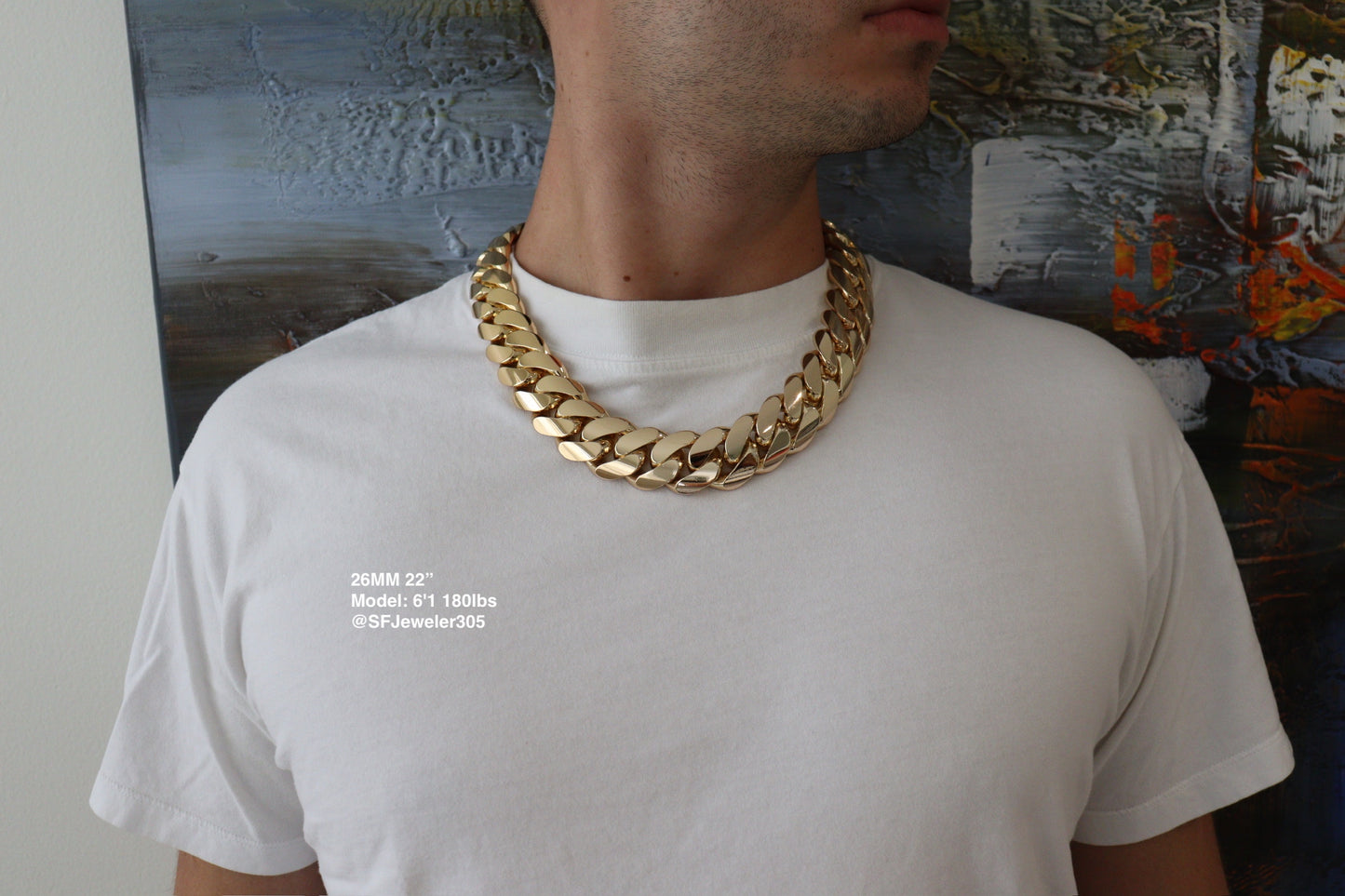 Man wearing a 26MM 22-inch yellow gold over silver Cuban link chain, modeled by SF Jeweler 305. The bold Miami Cuban chain has a heavy, polished finish and is styled with a casual t-shirt.