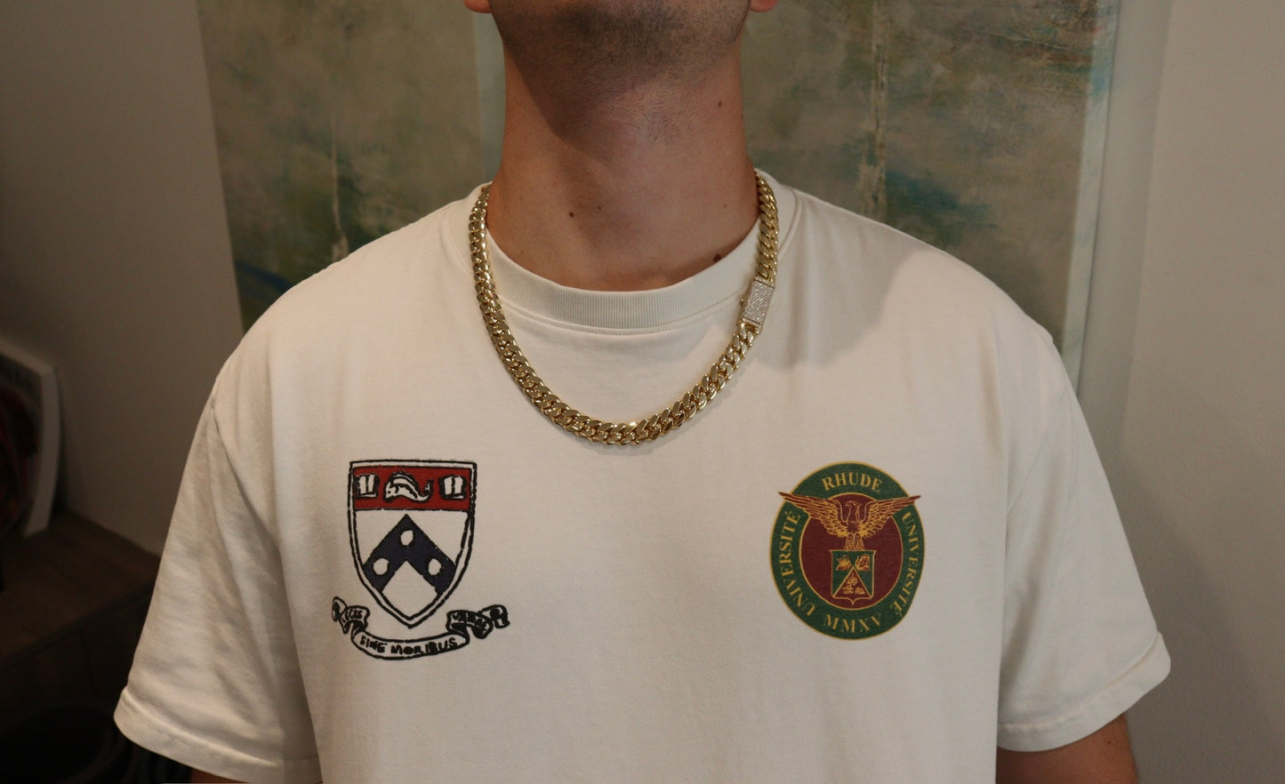 12MM Cuban Link Chain in yellow gold with fully iced-out VVS1 Moissanite Stones Lock, modeled on a 6’1” 180 lbs male wearing a white shirt. Jewelry by SF Jeweler 305.