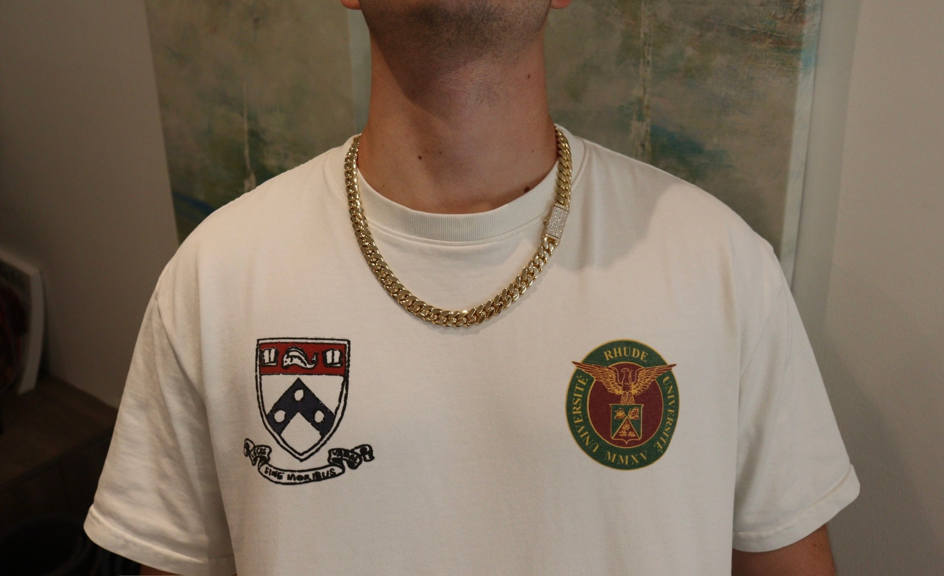 12MM Cuban Link Chain in yellow gold with fully iced-out VVS1 Moissanite Stones Lock, modeled on a 6’1” 180 lbs male wearing a white shirt. Jewelry by SF Jeweler 305.