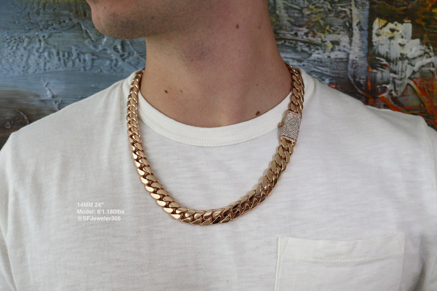 14MM Cuban Link Chain in rose gold over silver with fully iced-out VVS1 Moissanite Stones Lock, 24-inch length, modeled on a 6’1” 180 lbs male wearing a white shirt. Jewelry by SF Jeweler 305.