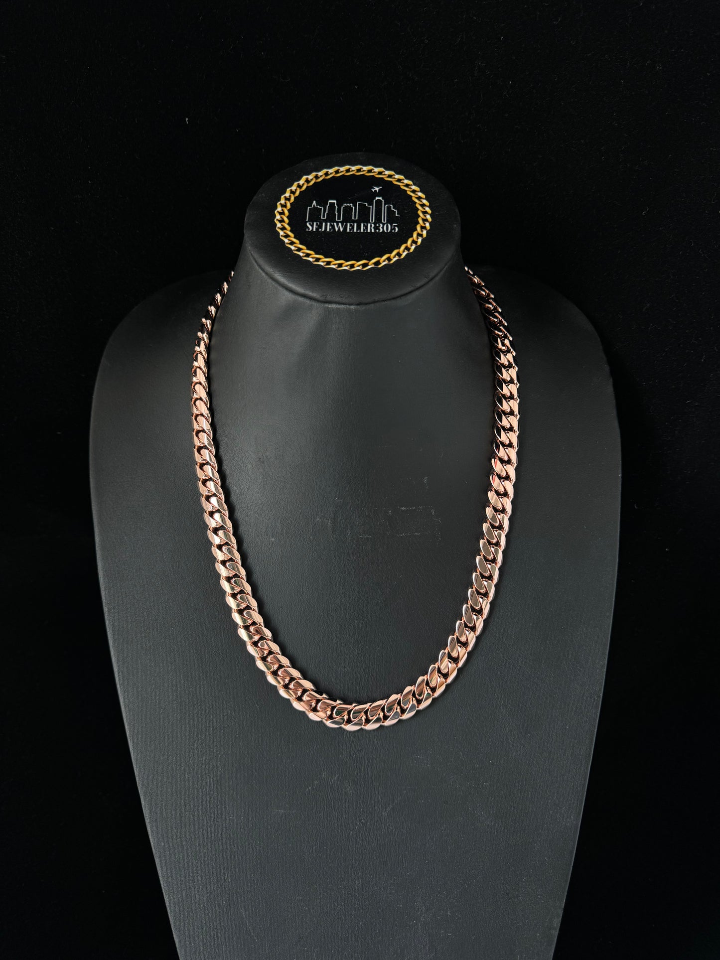 Man wearing a 10MM rose gold over silver Cuban link chain, modeled by SF Jeweler 305. The bold Miami Cuban chain has a heavy, polished finish and is styled with a casual t-shirt.