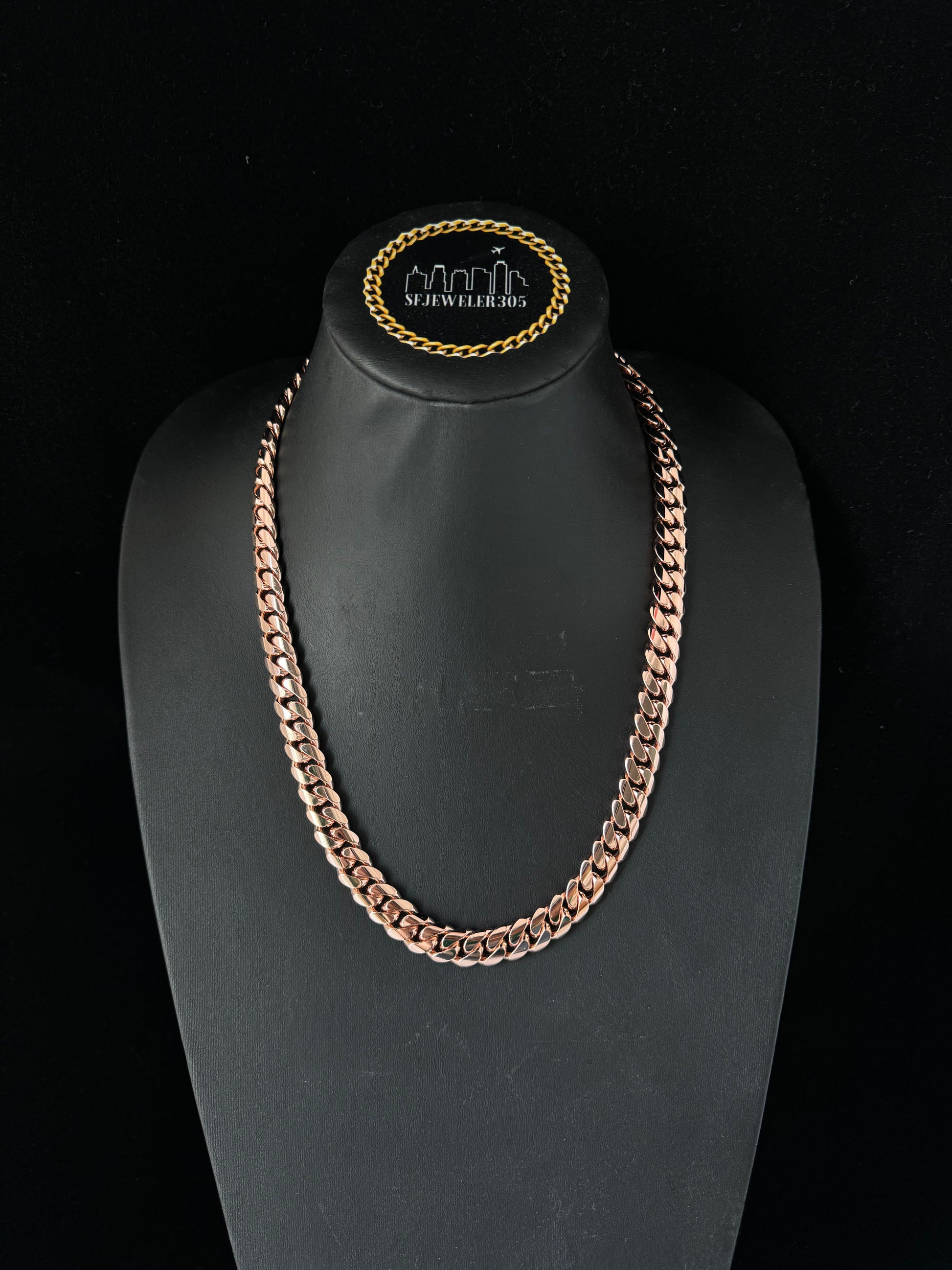 Man wearing a 10MM rose gold over silver Cuban link chain, modeled by SF Jeweler 305. The bold Miami Cuban chain has a heavy, polished finish and is styled with a casual t-shirt.