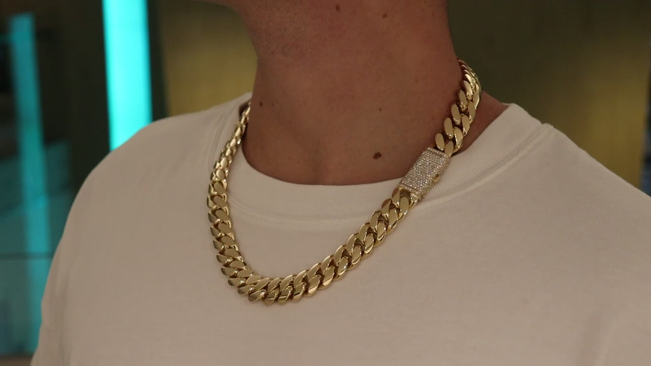 16MM Cuban Link Chain in rose gold over silver with fully iced-out VVS1 Moissanite Stones Lock, modeled on a 6’1” 180 lbs male wearing a white shirt. Jewelry by SF Jeweler 305.