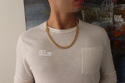 Man wearing a 10MM 24-inch yellow gold over silver Cuban link chain, modeled by SF Jeweler 305. The bold Miami Cuban chain has a heavy, polished finish and is styled with a casual t-shirt.