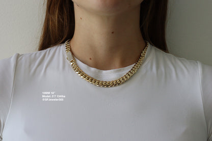 10MM 18 - inch Cuban Link Chain in yellow gold with fully iced-out VVS1 Moissanite Stones Lock, modeled on a 5’7” 134 lbs female wearing a white shirt. Jewelry by SF Jeweler 305.