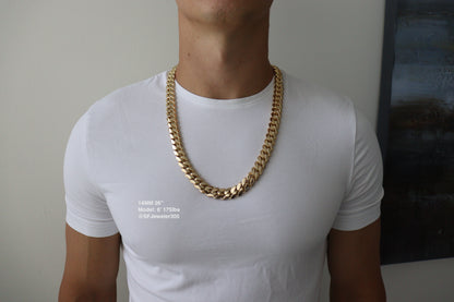 Man wearing a 14MM 26 inch yellow gold over silver Cuban link chain, modeled by SF Jeweler 305. The bold Miami Cuban chain has a heavy, polished finish and is styled with a casual t-shirt.