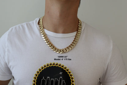 Man wearing a 16MM 22 inch yellow gold over silver Cuban link chain, modeled by SF Jeweler 305. The bold Miami Cuban chain has a heavy, polished finish and is styled with a casual t-shirt.