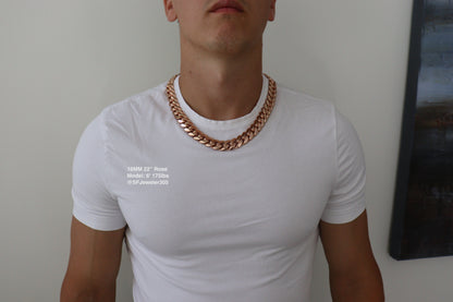 Man wearing a 16MM 22 inch rose gold over silver Cuban link chain, modeled by SF Jeweler 305. The bold Miami Cuban chain has a heavy, polished finish and is styled with a casual t-shirt.