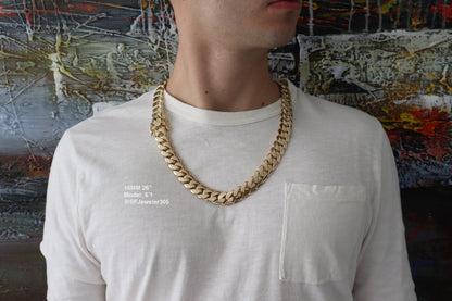 Man wearing a 16MM 26 inch yellow gold over silver Cuban link chain, modeled by SF Jeweler 305. The bold Miami Cuban chain has a heavy, polished finish and is styled with a casual t-shirt.