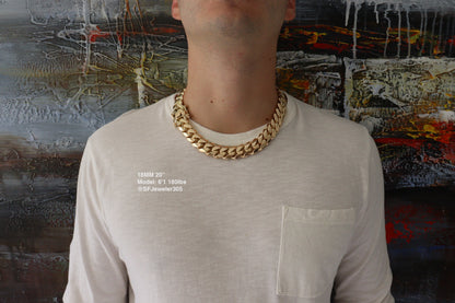 Man wearing a 18MM 20-inch Yellow gold over silver Cuban link chain, modeled by SF Jeweler 305. The bold Miami Cuban chain has a heavy, polished finish and is styled with a casual t-shirt.