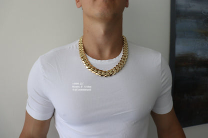 Man wearing a 18MM 22-inch Yellow gold over silver Cuban link chain, modeled by SF Jeweler 305. The bold Miami Cuban chain has a heavy, polished finish and is styled with a casual t-shirt.