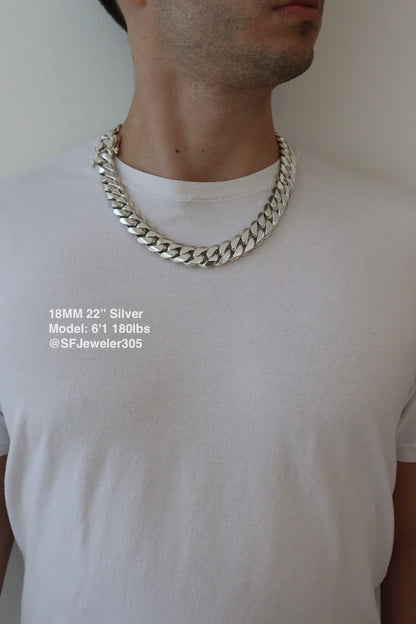 Man wearing a 18MM 22-inch .999 silver Cuban link chain, modeled by SF Jeweler 305. The bold Miami Cuban chain has a heavy, polished finish and is styled with a casual t-shirt.