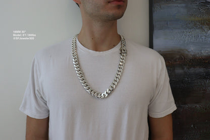 Man wearing a 18MM 30-inch .999 silver Cuban link chain, modeled by SF Jeweler 305. The bold Miami Cuban chain has a heavy, polished finish and is styled with a casual t-shirt.