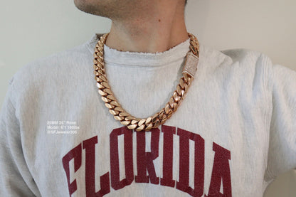 20MM Cuban Link Chain in rose gold with fully iced-out VVS1 Moissanite Stones Lock, 24-inch length, modeled on a 6’1” 180 lbs male wearing a white shirt. Jewelry by SF Jeweler 305.