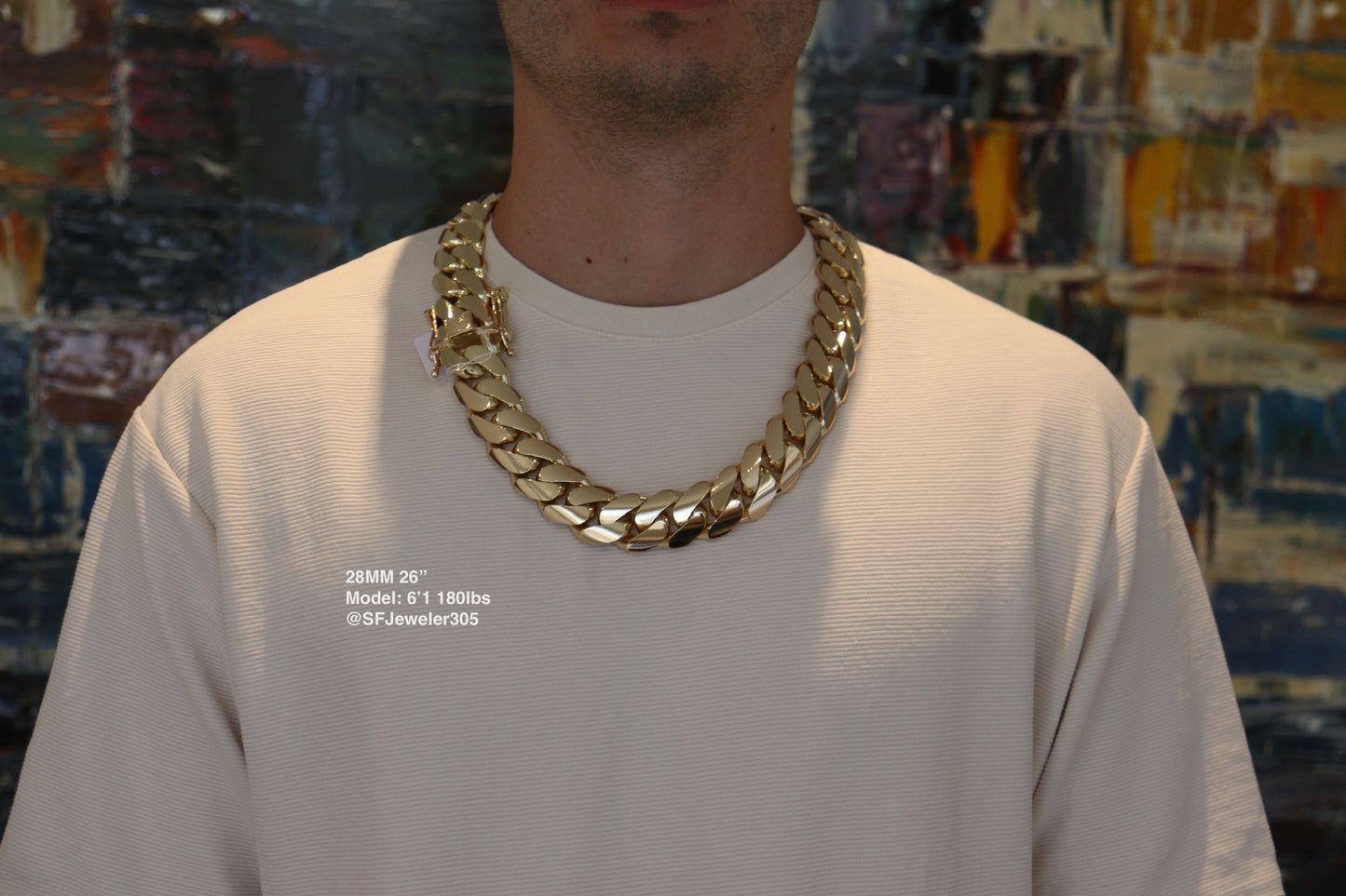 Man wearing a 28MM 26-inch yellow gold over silver Cuban link chain, modeled by SF Jeweler 305. The bold Miami Cuban chain has a heavy, polished finish and is styled with a casual t-shirt.