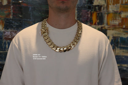 Man wearing a 28MM 26-inch yellow gold over silver Cuban link chain, modeled by SF Jeweler 305. The bold Miami Cuban chain has a heavy, polished finish and is styled with a casual t-shirt.