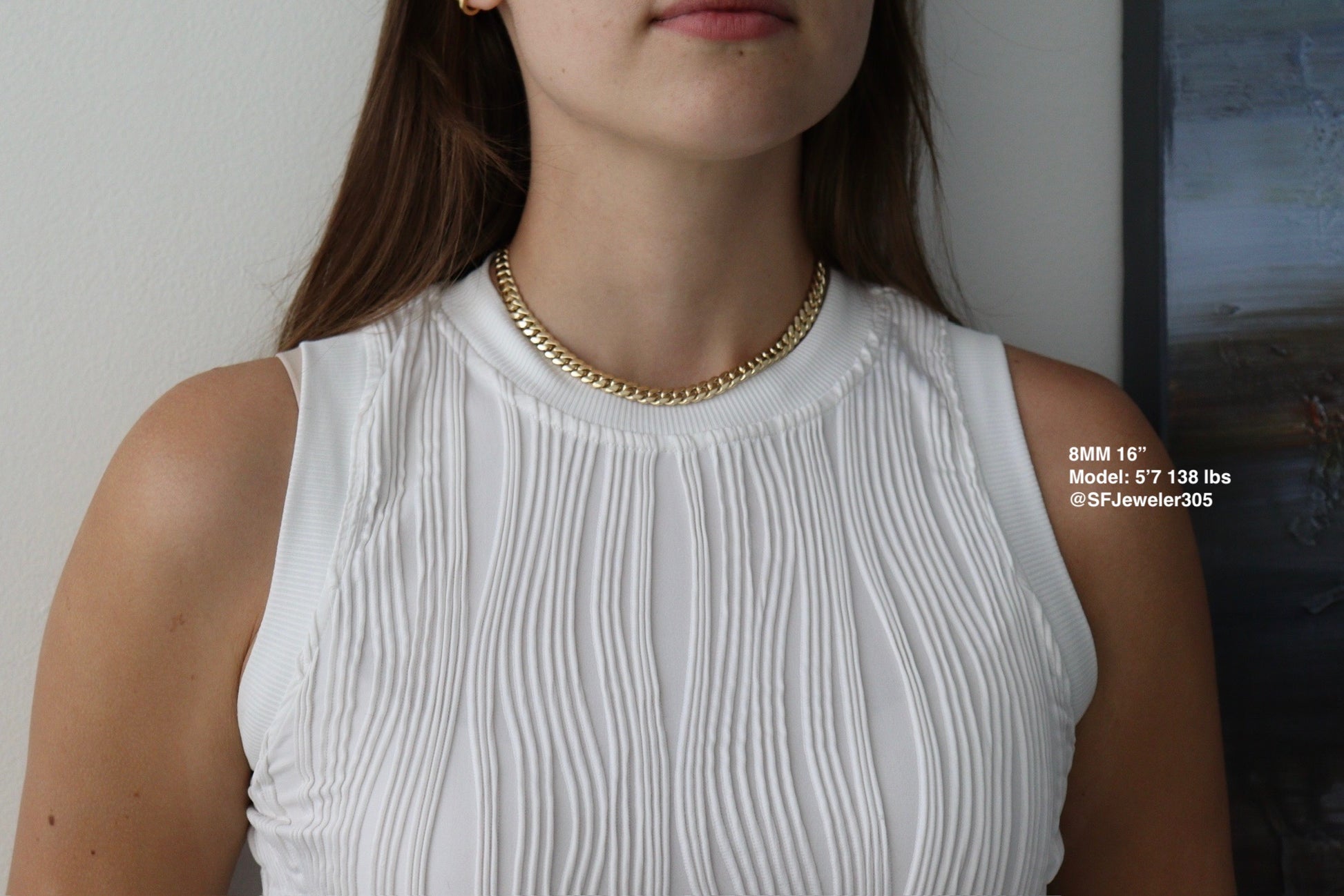 women wearing a 8MM 16-inch yellow gold over silver Cuban link chain, modeled by SF Jeweler 305. The bold Miami Cuban chain has a heavy, polished finish and is styled with a casual t-shirt.
