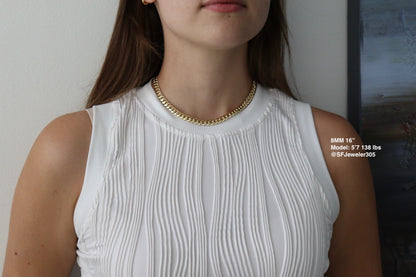 women wearing a 8MM 16-inch yellow gold over silver Cuban link chain, modeled by SF Jeweler 305. The bold Miami Cuban chain has a heavy, polished finish and is styled with a casual t-shirt.