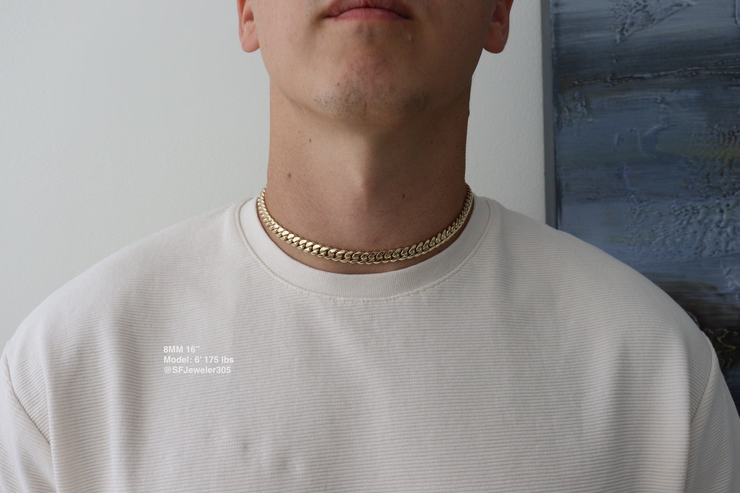 Man wearing a 8MM 16-inch yellow gold over silver Cuban link chain, modeled by SF Jeweler 305. The bold Miami Cuban chain has a heavy, polished finish and is styled with a casual t-shirt.