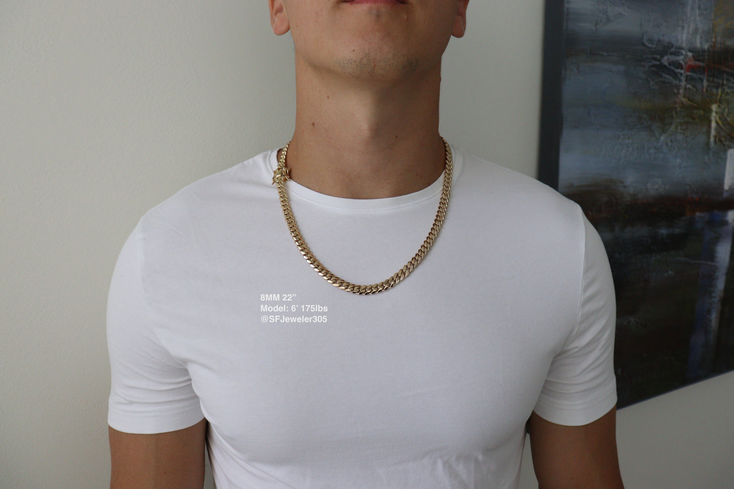 Man wearing a 8MM 22-inch yellow gold over silver Cuban link chain, modeled by SF Jeweler 305. The bold Miami Cuban chain has a heavy, polished finish and is styled with a casual t-shirt.