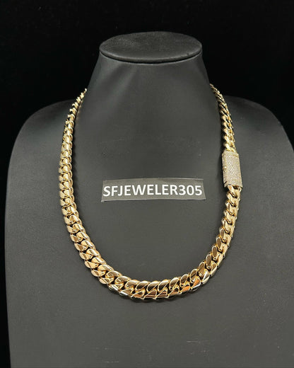 12MM Cuban Link Chain in yellow gold over silver with fully iced-out VVS1 Moissanite Stones Lock, modeled on a 6’1” 180 lbs male wearing a white shirt. Jewelry by SF Jeweler 305.