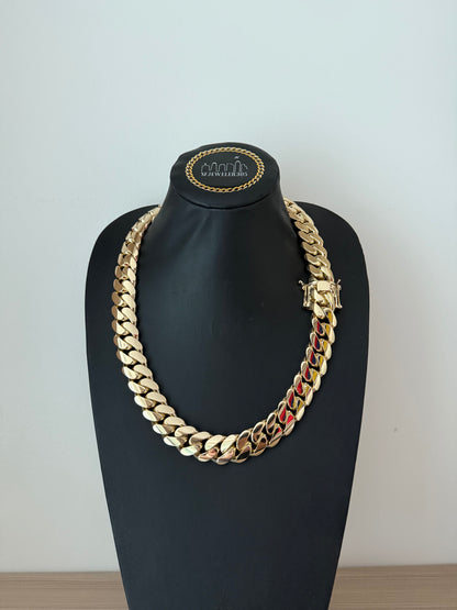 22MM yellow gold over silver Cuban link chain, modeled by SF Jeweler 305. The bold Miami Cuban chain has a heavy, polished finish and is styled with a casual t-shirt.
