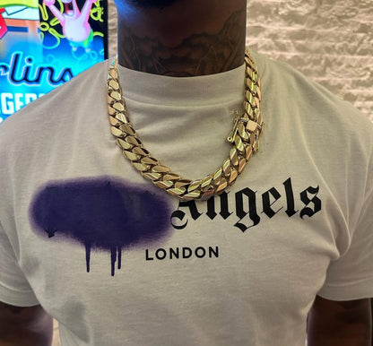 Man wearing a 22MM yellow gold over silver Cuban link chain, modeled by SF Jeweler 305. The bold Miami Cuban chain has a heavy, polished finish and is styled with a casual t-shirt.