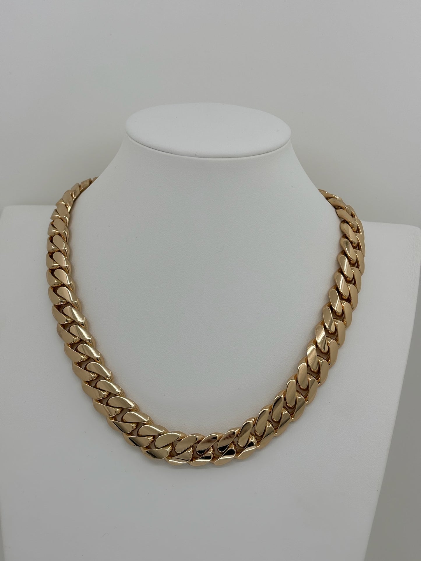 20MM yellow gold over silver Cuban link chain, modeled by SF Jeweler 305. The bold Miami Cuban chain has a heavy, polished finish and is styled with a casual t-shirt.
